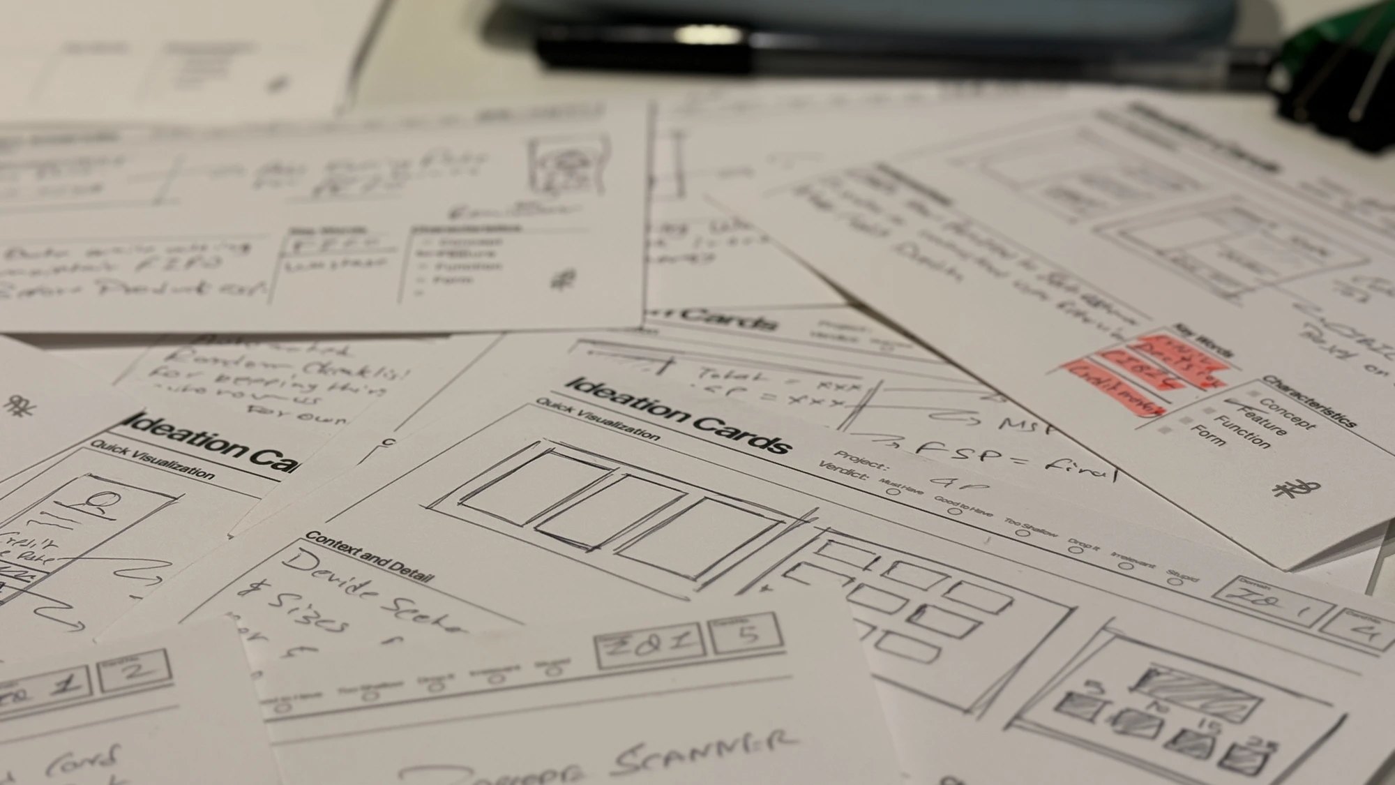 Ideation cards spread across the studio table