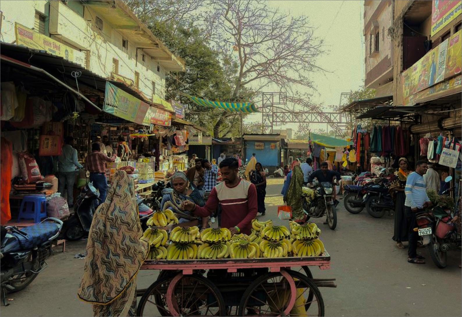 The market street — carts, cycles and morning trade